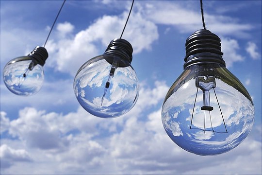picture of three lightbulbs in front of a blue sky
